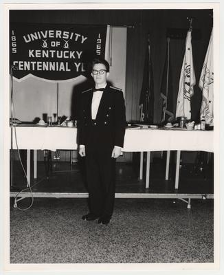 A man possibly named Sanderson is attending a banquet for the University of Kentucky Centennial Year