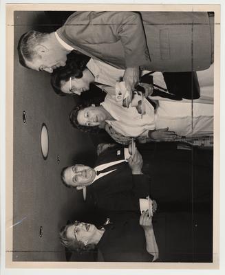 President Frank Dickey having tea with a group of unidentified people