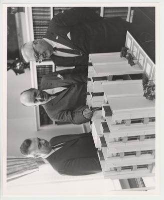 From the Left: University of Kentucky president Frank Dickey, Architect Edward Durell Stone, and State Finance Commissioner David H. Pritchett inspecting a cutaway model of the University of Kentucky's proposed undergraduate student housing complex, the Kirwan-Blanding Dorm Complex