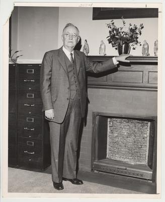 Doctor Donovan after his retirement from the University of Kentucky in 1956.  He is standing by a fireplace with file cabinets beside it.  This photo is in the 1962 Kentuckian on page 222
