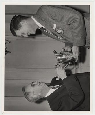 Albert Kirwan presenting the Optimist Cup to former president Donovan
