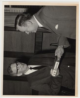 President Albert Kirwan (left) with an unidentified man holding The American Legion Story