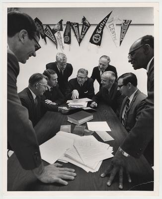 The first meeting of the Editorial Board of the University Press of Kentucky.  From left to right: Dean William M. Jones, Berea College; Doctor Victor B. Howard, Morehead State University; Doctor Lowell H. Harrison, Western Kentucky University; Doctor Richard M. Kain, University of Louisville; Doctor Albert Kirwan, University of Kentucky; Dean Frederic D. Ogden, Eastern Kentucky University; Doctor Charles T. Hazelrigg, Centre College; Vance Ramage, Murray State University; Doctor Henry E. Cheaney, Kentucky State University