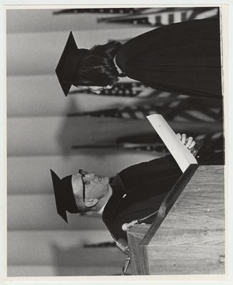 Albert Kirwan speaking to a student at a graduation ceremony