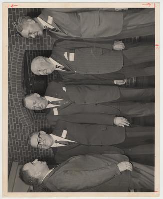 President John Oswald (far left) is talking with a group of unidentified men