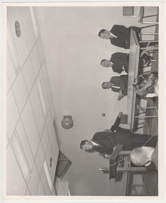 Governor Bert Combs, seated second from the left, and president John Oswald, laughing while listening to a speaker at the Agriculture Science Center dedication on December 5, 1963