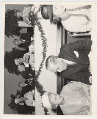 President John Oswald (third from the left), son John Oswald Junior (second from the left), and other unidentified people seated at President Oswald's inaugural luncheon in the Student Center Ballroom