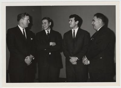 President John Oswald, far right, with two unidentified student and one unidentified man
