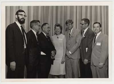 President Oswald (third from left), Sara Holroyd (director of the University of Kentucky Chorale Music Group), JW Patterson (third from right) and four unidentified men