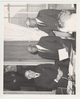 President John Oswald (left) handing an award to an unidentified man