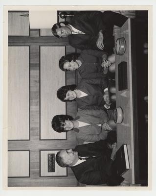 President John Oswald (far left) seated with four unidentified individuals