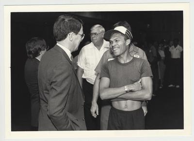 President Roselle (left) socializing with unidentified people at the Physical Plant reception