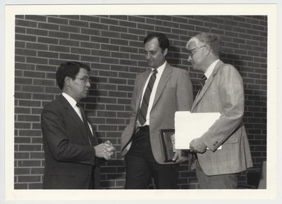 President Roselle (left) standing with doctor Ben Carr (center) and Paul Willis (right) at the University Senate meeting
