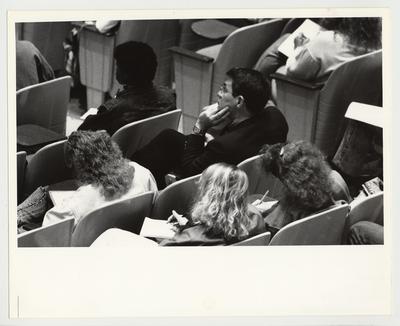 President Roselle seated with a large group of students, listening to a lecture