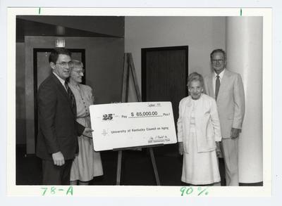 President Roselle (far right presenting a $65,000 check to the University Council on Aging