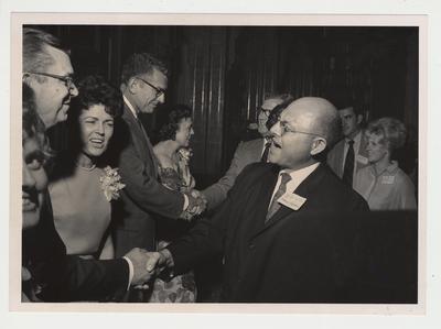 President Singletary and Gloria Singletary in a receiving line at a reception at Spindletop.  Howard Hopkins of the pharmacy is at the from of the picture