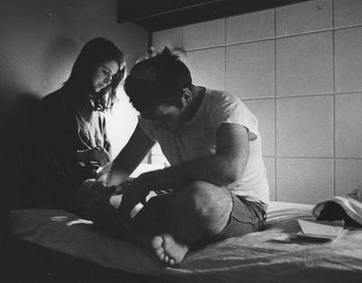 A man and woman studying in the Graduate Co-ed Dorms in the Kirwan-Blanding Towers in 1969. This photo appears first on page 205 of the 1969 