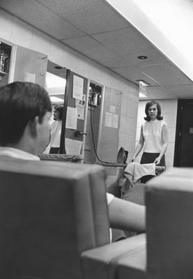 A woman ironing while a man is talking to her in the Graduate Co-ed Dorms in the Kirwan-Blanding Complex in 1969. This photo appears second on page 205 of the 1969 