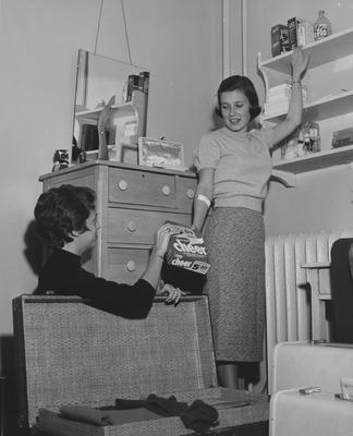 Suzanne Freed (left) and Margaret Futwell (right) are unpacking in a dorm room