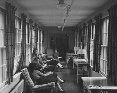 Five unidentified women are reading in the bridge/hallway between Patterson and Boyd Halls