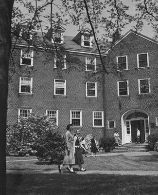 Seven unidentified women in front of Boyd Hall, a woman's dormitory. Boyd Hall was built in 1925 and was named after Cleona Boyd