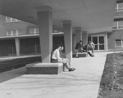 Six unidentified men are talking in front of Donovan Hall