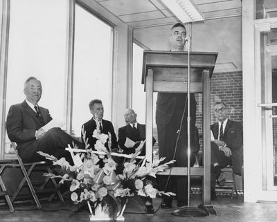 Former President Herman Donovan (far left) and four unidentified men are seated listening to President Frank Dickey speak at the dedication of Haggin Hall on September 16, 1960. Photographer: Herald-Leader