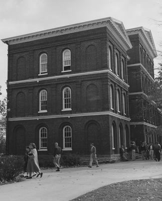 White Hall Dormitory from the side next to the Administration Building. Students passing the 