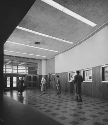 Unidentified students walking past the entrance to the Art Gallery,  which is inside the Fine Arts Building. Photographer: Sound Business Magazine