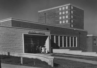 Unidentified women and men are exiting through the front doors of the Finr Arts Building. Photographer: J. B. Kuiper. Received August 16, 1958 from Public Relations