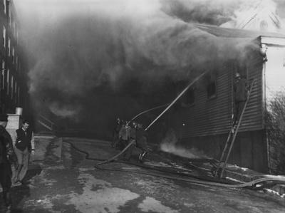 Firefighters trying to extinguish the fire. Guignol, on January 10, 1947, engulfed in flames. Photographer: W. E. Sutherland