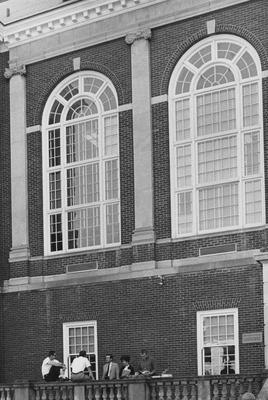 Students sitting on the porch of the King Library. Received September 3, 1965 from Public Relations. Photographer: R. R. Rodney Boyce