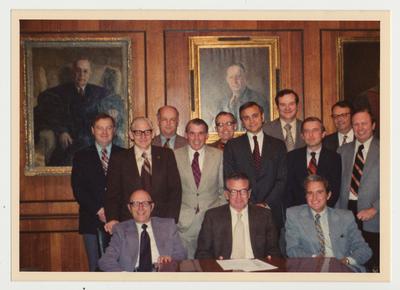 Department heads in the Board of Trustees Board Room.  First Row:  A. D. Albright, Vice President of Institutional Planning; Otis Singletary; unidentified man.  Second Row:  John Darsie, Legal Counsel; unidentified man; Larry Forgy, Vice President for Business Affairs; Jim Ruschell, Acting Vice President for Business Affairs; unidentified man.  Third Row:  Stan Wall, Vice President Community Colleges; Peter Bosomworth, Chancellor of the Medical Center; Don Clapp, Vice President of Fiscal Affairs