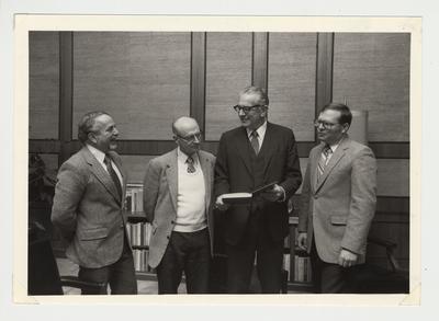 From the left:  Peter Sehlinger, Charles Roland, President Otis Singletary, and Jim Klotter.  They are looking at Holman Hamilton's book.  Holman Hamilton was a history professor
