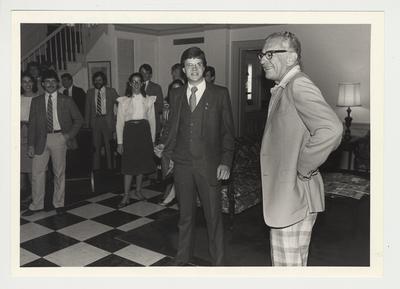 President Singletary (right) is standing with Mr. Breen (second from right), President of Mortar Board, and other unidentified people at the surprise birthday party given by the Mortar Board.  The party was to celebrate President Singletary's sixtieth birthday