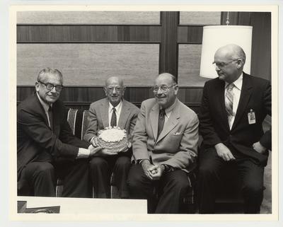From the left:  President Singletary; Floyd Wright; William Sturgill;  and Peter Bosomworth; Chancellor of the Medical Center.  Floyd Wright is being presented with a birthday cake