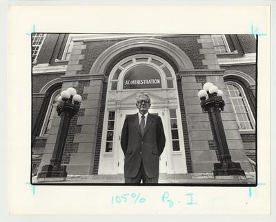 President Singletary is standing in front of the front door of the Administration / Main Building