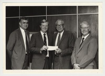 Dave Guin is presenting a check for the University of Kentucky to President Singletary.  From the left:  Ray Hornback, Vice President; Dave Guin, Jiff Peanut Butter Company (Proctor and Gamble); President Singletary; and Steve Currie, Coca Cola Company