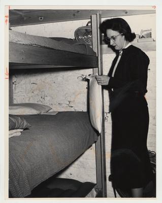 Betty Dickey is in a model fallout shelter for civil defense during the Cold War