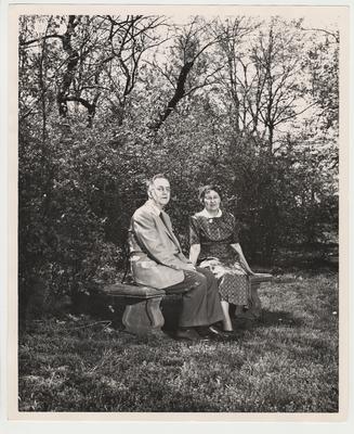Nell Donovan (right) and President Donovan (left) are seated on a bench outside