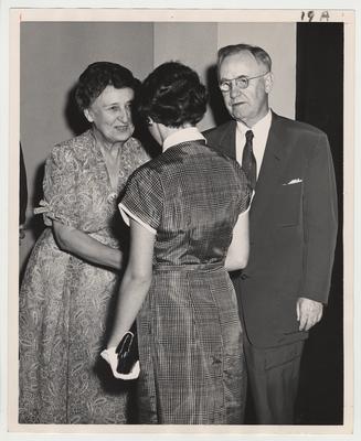 President Donovan and Nell Donovan are greeting an unidentified woman