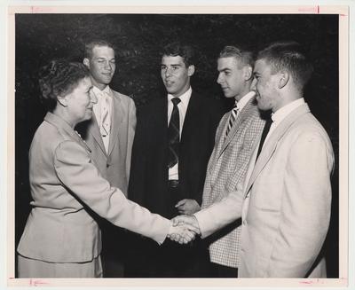 Nell Donovan (far left) is shaking Jim Nixon's (of Harlan, far right) hand and standing with Joe Lister of Lexington (second from left), Johnny Bickwell of Lexington (third from left), and Bob Lawrence of Lexington (second from right)