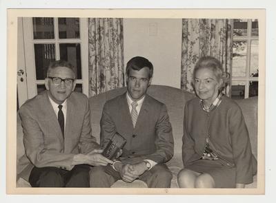 Dr. Albert Kirwan (left) with his spouse Elizabeth (right and an unidentified student (center). Dr. Kirwan is presenting the student with an award