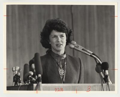 Louise Roselle is standing at a podium and speaking at an unidentified event