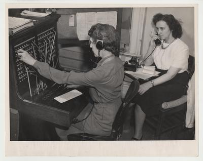 Two unidentified women are operating a switchboard
