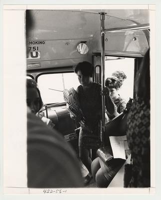 An unidentified female student is boarding a bus.  This bus was part of the new campus bus service, which began in 1969