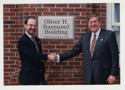 Oliver H. Raymond (right) is shaking hands with Thomas W. Lester (left), Dean of Engineering, at the dedication of the Oliver H. Raymond Building
