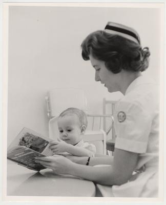 Linda Enslen, student nurse, entertains a young child