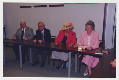 Nancy Baird (far right), Carol Crowe Carrico (second from right), Leonard Curry (second from left) and Walter Baker, State Senator (far let) are seated around a table at Dr. Thomas D. Clark's 100th birthday celebration at Young Library