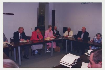 Mary Wilma Hargreaves (far right), Jerry Crouch (second from right) Robert Sexton (third from right), Dr., Thomas Clark (center), Nancy Baird (third from left), Carol Crowe Carrico (second from left) and Leonard Curry (far left) are seated around a table at Dr. Thomas D. Clark's 100th birthday celebration at Young Library